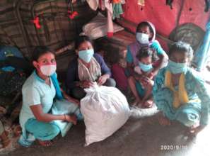 Families receiving food rations in New Delhi