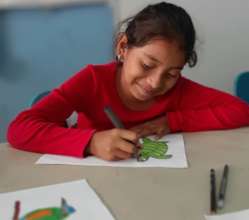 Young girl working on drawing for the contest