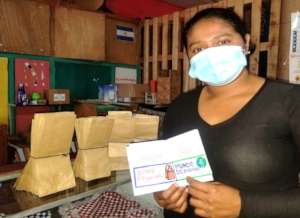 Mother shows stampted pasport for bags project.