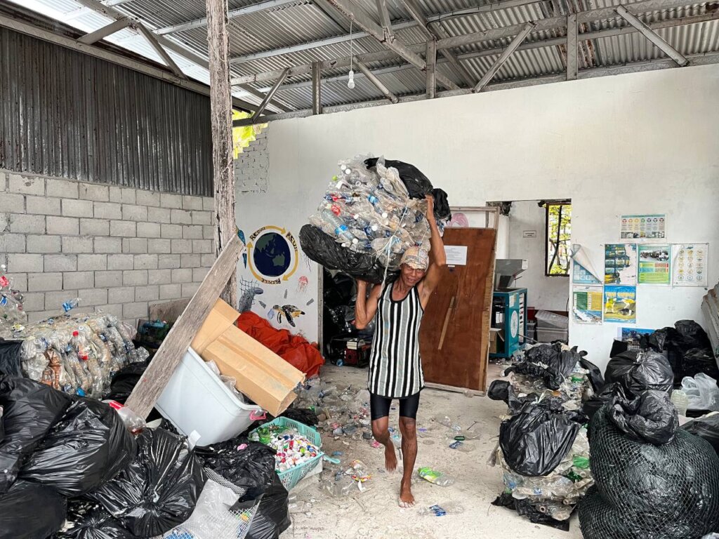 A local islander preparing trash to be shipped off