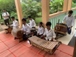 Lya playing Khmer traditional music at SCC office