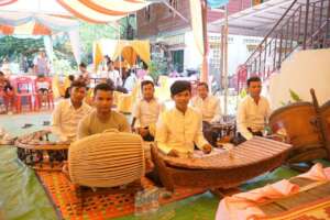 Nuy is playing traditional music at a ceremony
