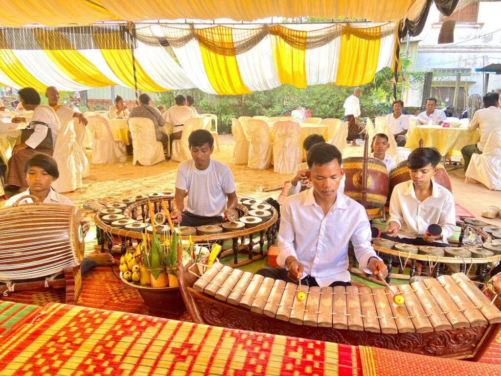Yuth performs traditional Khmer music in a village