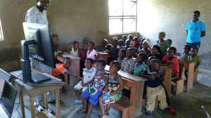 Children watching video lesson in Olosun Village