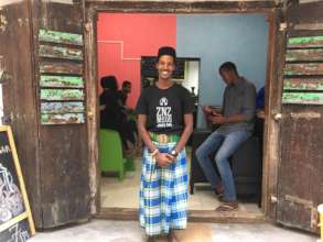 Our student, Feisal, in front of his juice shop