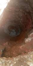 A fundi using just a pick-axe to dig our new well