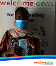 A student shows off her vaccine card