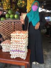 Wahida selling her small business' eggs to a cafe