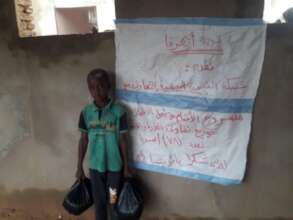 A little boy with a sack of seed
