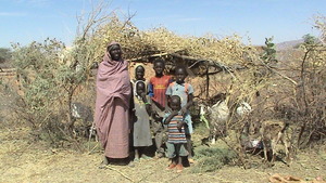 A family outside their home in the Saharan heat