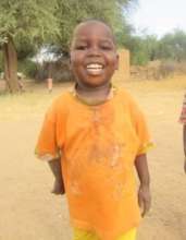 A smiling happy boy prepares for his new goats!