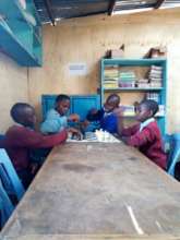 Students at Mathare 4b SoH learning to play chess