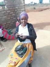 A group member crocheting a beanie