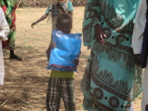 Child holding a mosquito net