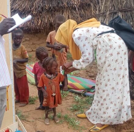 Children are measured to monitor malnutrition