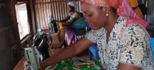 A refugee woman in sewing class