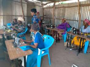 Wome at a sewing training session.