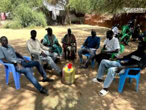 Small circle sharing current challenges in camp