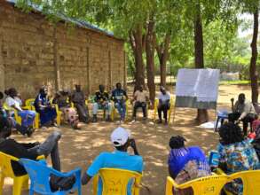 Participants learning under the tree in camp