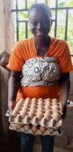 Zakiya holding two crates of eggs