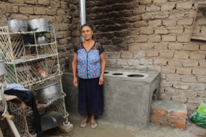 Beneficiary and her new ecological cookstove