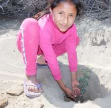 Community member planting an Algarrobo tree