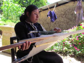 Young artisan weaving traditional wool