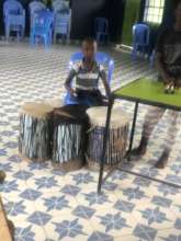 Leone in 1st grade playing traditional drums