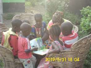 Reading with Restore Hope's youngest students