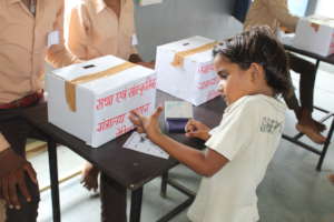 Student casting her vote for Child parliament