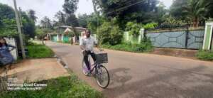 Mr Percy riding his bicycle to work
