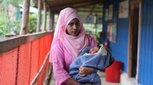 Nasrin holding the baby she helped deliver.
