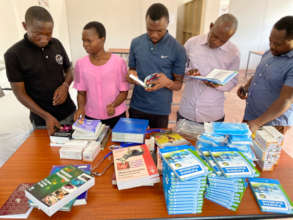 Handing over textbooks at Sokoine University