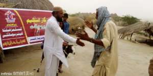 Goat being handed over to a disabled person