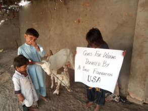 Happy children with the goat