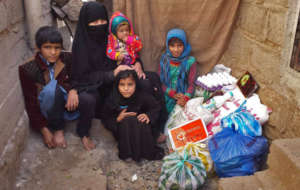 Yemeni family with their emergency food supplies.