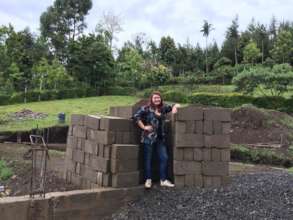 Volunteer with a load of bricks she donated