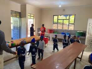 The children enjoying Cook's delicious porridge