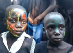 Students put on paint at a toilet opening