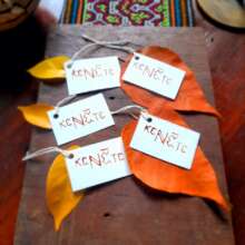 Tags from reused paper, achiote, leaves and cotton
