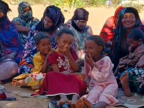 Girls play at Jikat's community education meeting