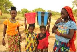 Fulani girls transporting water 1.5 miles.