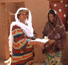 Mentor Tarbane receives letter from RAIN's Rabi (left)