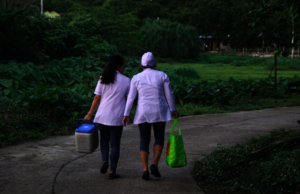 Community health workers transporting TB materials