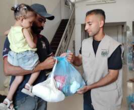 Arjwan and her family receiving a parcel