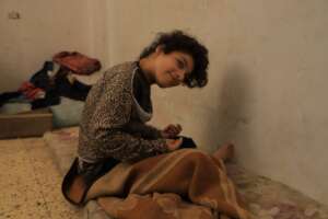 Mena sitting in her room