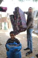Kareem with mattresses, little Kareem helping!