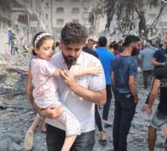 Father and child pass demolished homes