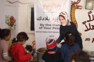 Lead of neighborhood cooking team giving meals