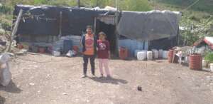 Embrah and Ana in front of their home.